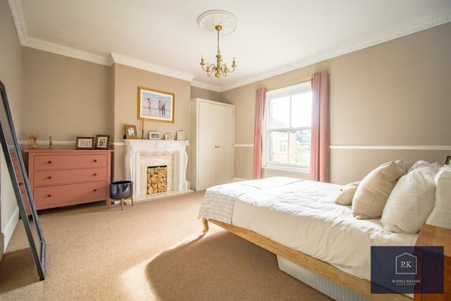 There are four bedrooms in this house - two are generously-sized doubles with feature fireplaces and built-in wardrobes