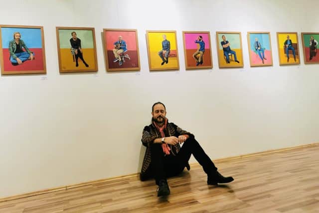 Nick Lang with some of his paintings
