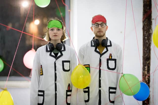 Two Scientists surrounded by balloons