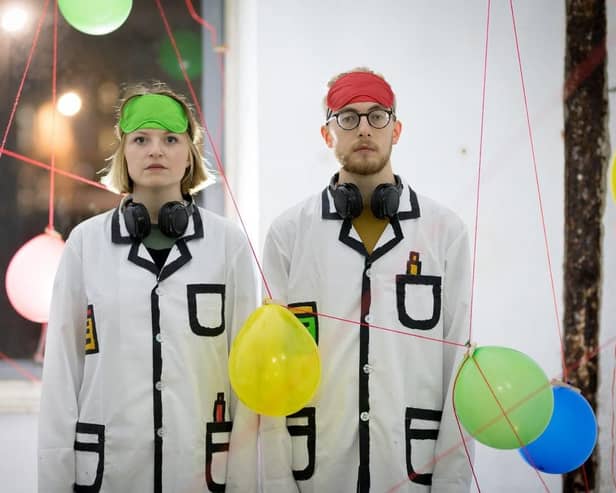 Two Scientists surrounded by balloons