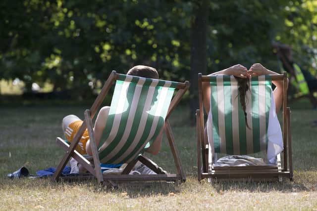 A couple relax on deckchairs in the warm weather. The Met Office has issued a heatwave alert as temperatures soar to their highest of the year.  (Photo by Oli Scarff/Getty Images)