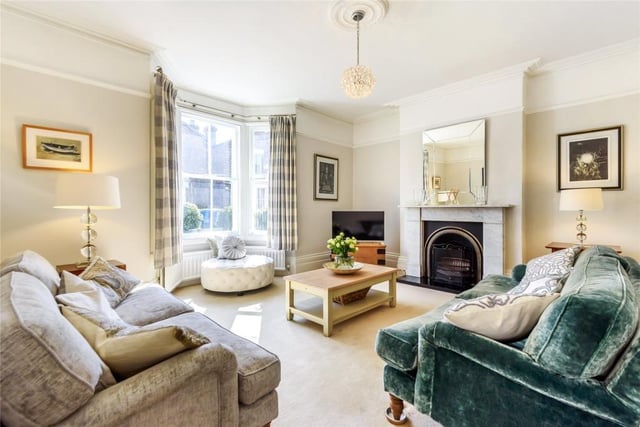 This room - which measures 17ft 6in by 14ft - has an original marble fireplace with a raised hearth and open grate, and a deep bay window overlooking the front garden