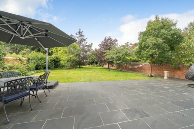 The bi-fold doors from the kitchen/living area open to an extensive paved terrace for outside dining and entertaining. The rest of the garden has a shaped central lawn with borders stocked with established trees, shrubs and flowers