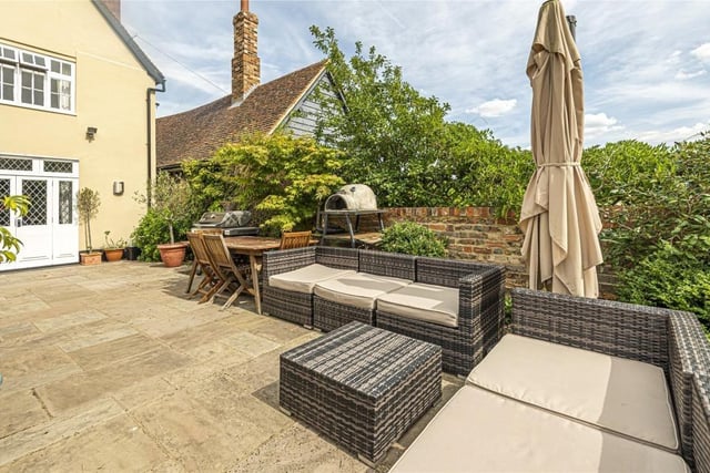 The landscaped rear garden is principally lawned with flower and vegetable borders and a flagstone terrace area