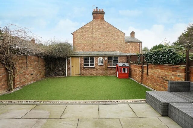 The private rear garden - measuring 28ft by 25ft - has had a makeover with sandstone patio, leading to artificial turf. The garden is walled with gated access to the side and a courtesy door to the garage