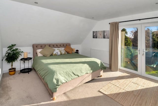 This room features French doors looking out on to the garden with a glass Juliet balcony. It also boasts a walk-in closet and an en suite shower room with an illuminated anti-mist mirror