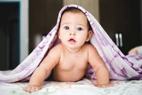 File photo of a baby under a blanket. Photo by Jonathan Borba on Unsplash