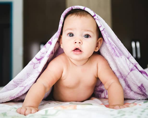 File photo of a baby under a blanket. Photo by Jonathan Borba on Unsplash