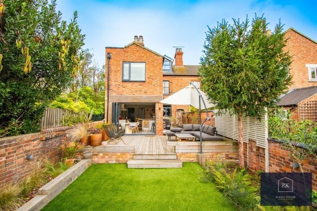 The landscaped split level south facing rear garden boasts a large decking area ideal for hosting. The remainder of the garden has a finish of artificial grass with mature shrub borders and to the rear is a summerhouse currently used by the owners as a hobbies/office area