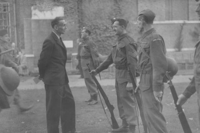 Soldiers of the Home Guard lined up for inspection, as Professor Ogilvie looks on, at Bedford College, in 1941.