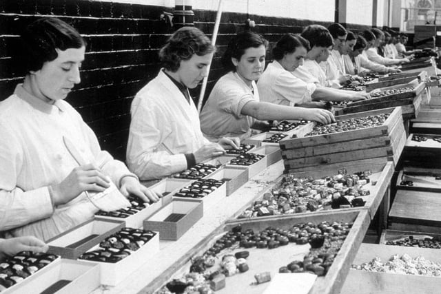 Workers packing Christmas chocolates at the Meltis sweet factory in Bedford on 24th November 1936.
