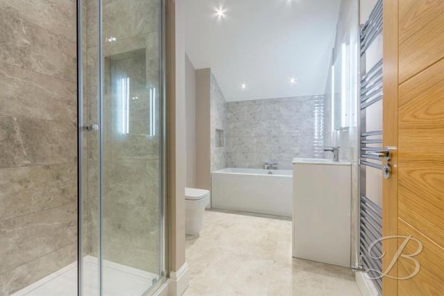 As you would expect from a property of such high quality, the family bathroom features contemporary fixtures and fittings. It comprises bath, walk-in shower, wash basin and vanity unit, low-flush WC and heated towel-rail. The tiling is stunning.