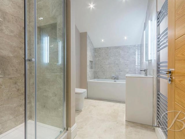 As you would expect from a property of such high quality, the family bathroom features contemporary fixtures and fittings. It comprises bath, walk-in shower, wash basin and vanity unit, low-flush WC and heated towel-rail. The tiling is stunning.