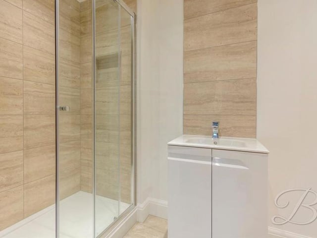 This walk-in shower is part of the en suite facilities for the downstairs bedroom.