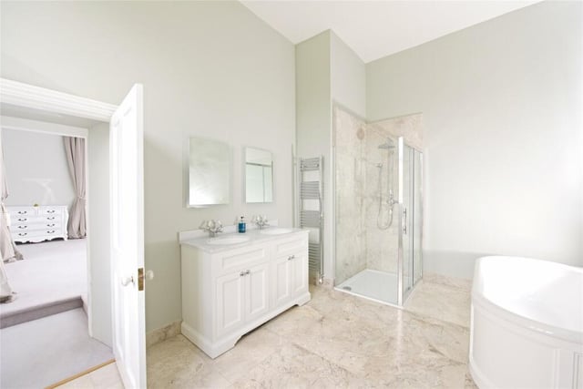 The en suite has a Burlington suite which includes a bath, a separate shower cubicle and twin vanity washbasins. A connecting door leads to the dressing room which is so big,  it could be used as another double bedroom or nursery