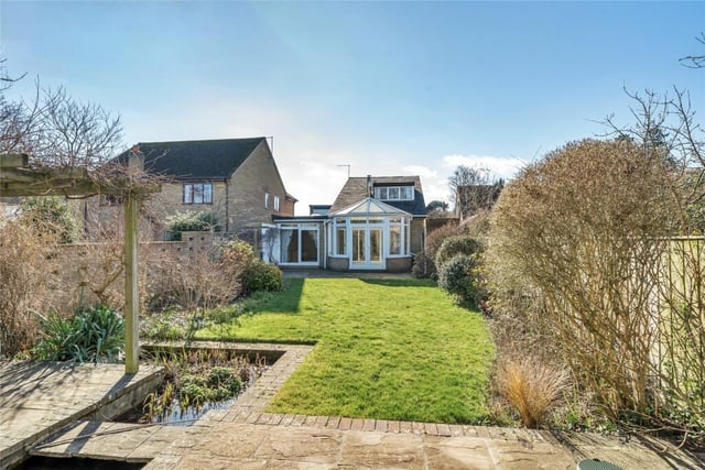 The rear garden is principally lawned with flower and shrub borders, two patio areas, a vine covered pergola, a pond and water feature. There is also a detached brick-built garden store/workshop with power connected and a brick-built potting shed