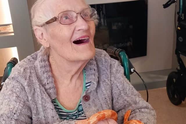 Marion Lomax, aged 92, with a snake