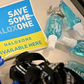 Naloxone available here stickers (Photo by JEFF J MITCHELL/POOL/AFP via Getty Images)