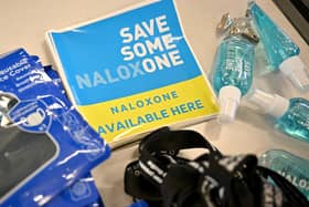 Naloxone available here stickers (Photo by JEFF J MITCHELL/POOL/AFP via Getty Images)