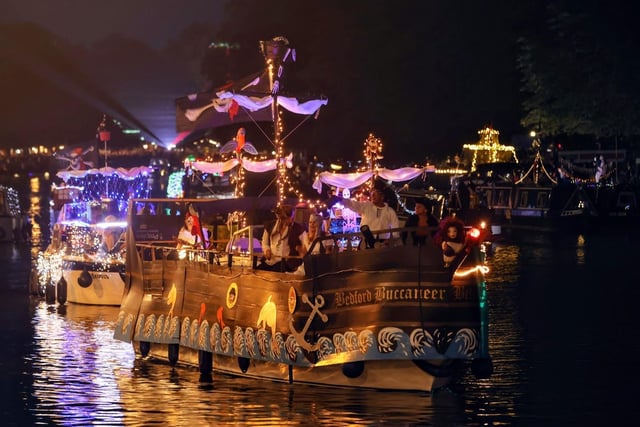 Illuminated boat parade lights up the river in Bedford.