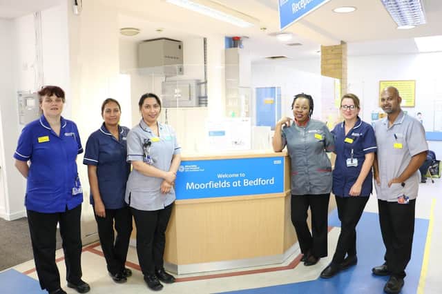 Moorfields eyecare services staff standing at reception. Pic: Moorfields Eye Hospital