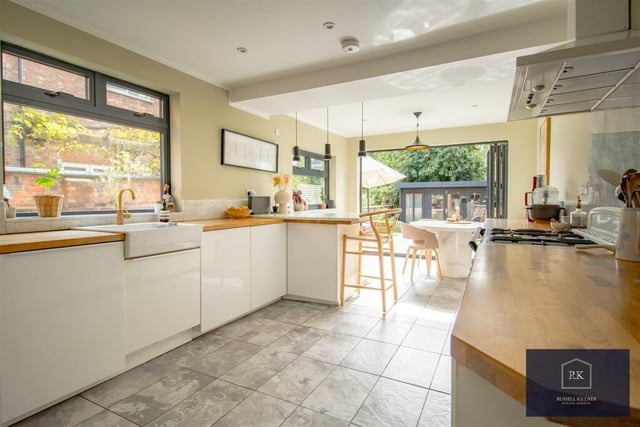 The traditional kitchen dining area has underfloor heating, a range of high and low level units, breakfast bar, butler-style sink, a Rangemaster cooker and bi-folding doors