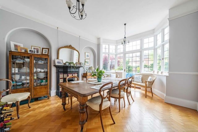 This beautiful rear dining room boasts as original cast iron fireplace plus the large bay window with door opening to the rear garden