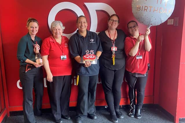 The team at QD’s Bedford store celebrating its 25th anniversary.