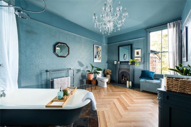 This room is a major feature of the house and includes a corner ball and claw footed bath with a Monsoon style shower and a wash basin set on a painted traditional-style vanity unit. There is a feature fireplace and a slate tiled and parquet floor