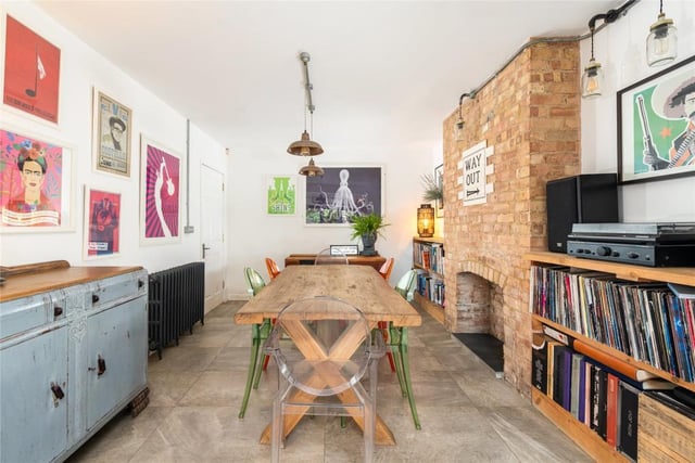 This room has an exposed porcelain floor by Fired Earth and an exposed brick chimney breast - it measures 23ft 5in by 19ft