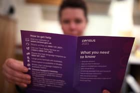 A woman reading a leaflet from the Office for National Statistics about The Census 2021