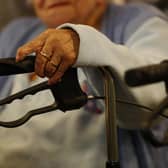 An elderly woman with her walker