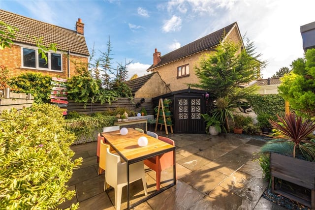 The east-facing rear garden has been professionally landscaped and includes an extensive paved terrace with raised beds set around the edge. In one corner there is a timber summerhouse with power