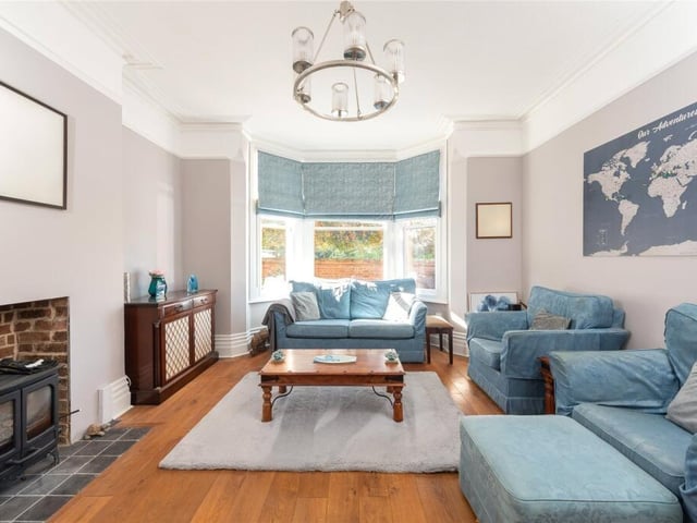 The family room has a fireplace recess housing a log burning stove