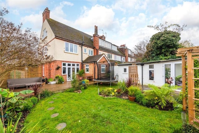 A gated access and pathway leads to the rear garden which has a paved area outside the garden room. The rest is principally lawned with borders of established trees and shrubs. Gated rear access leads to the single garage