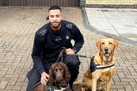 Prison dog handler Kane Walker pictured with his two dogs, Duke, a cocker spaniel, and Jake, a Labrador