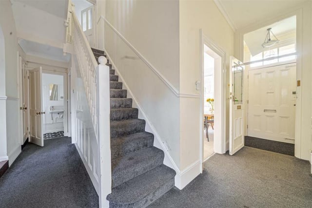 The spacious entrance features staircase to the first floor and two cellar rooms accessed via door from under the stairs