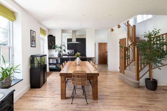 A very stylish open-plan living space with this dining area in the middle and a kitchen at one end with the living space at the other. There is also a separate study/snug