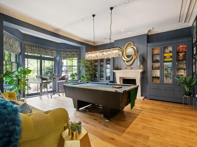 There's even a billiards room in this fabulous house with doors leading to the garden