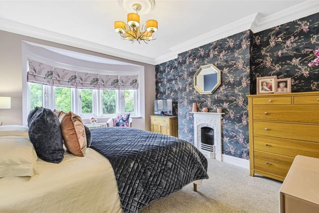 This room measures 15ft 6in by 11ft 9in - it also boasts a traditional cast iron fireplace