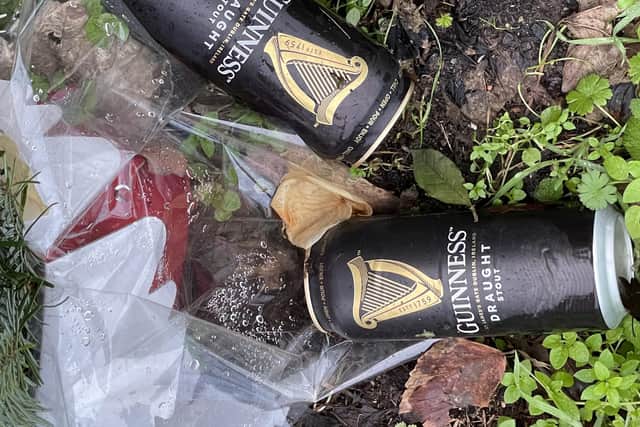 Several bunches of flowers and four Guinness cans still mark the spot