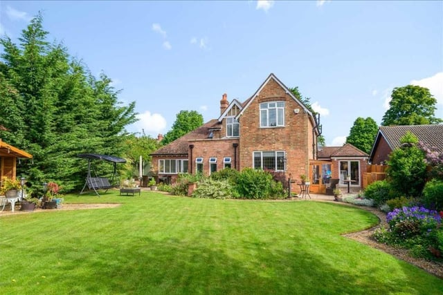 Outside the property is accessed via double gates to a large gravel driveway providing parking for several vehicles, a double garage with power and light connected, and a large well-stocked rear garden
