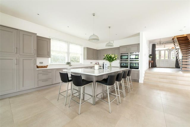 The stylish open plan kitchen/breakfast room extends across about two thirds of the width at the rear of the house and has two sets of French doors to the rear terrace. Porcelain tiled flooring continues into the breakfast area which has dual aspect windows, two skylight windows, and steps up to the inner hall in the original part of the property
