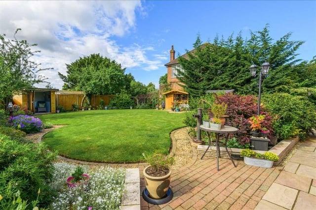 The rear garden has a summer house and extensive private patio