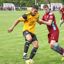 Bedford's Lynton Goss holds off a Welwyn player. Photo: Adrian Brown.