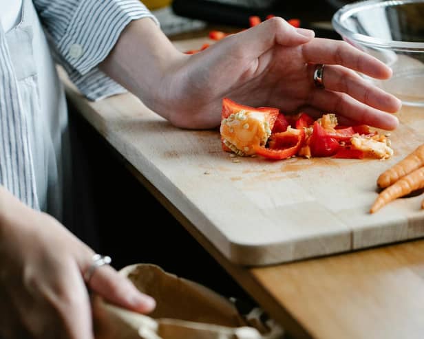 File image of person putting food waste into a bag (image: Pexels)