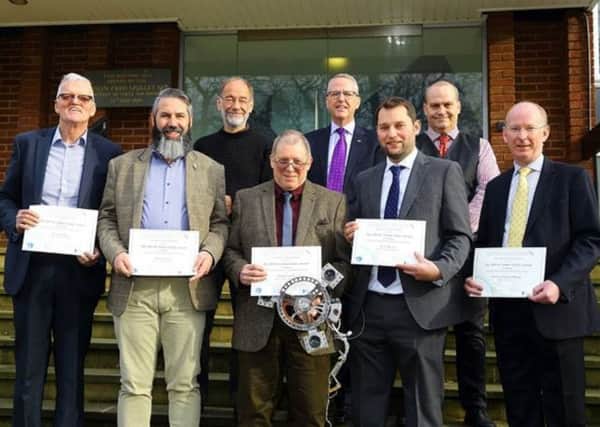 Dr Jim Clemmet (first left, back row) presents Ampthill engineers with certificates for their contribution to the Beagle 2 mission.