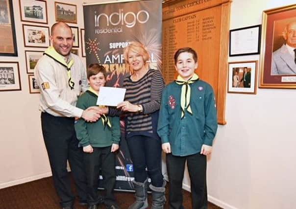 Committee chairman Liz Perry, handing over a donation to a local Scouting group