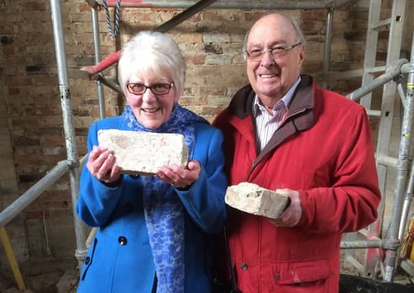 Daphne Waugh and Colin Deas with the first bricks.