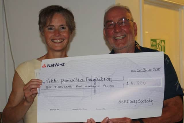 Sarah Russell, Chief Executive of Tibbs Dementia Foundation, receiving a cheque for Â£6,500 from Dermot Horan, Deputy Chairman of St Philip & St James Golf Society